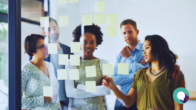 Blog header image with stock photography of business people making an action plan, overlain with blog article title Steps Local Businesses Can Take Amid Tariffs