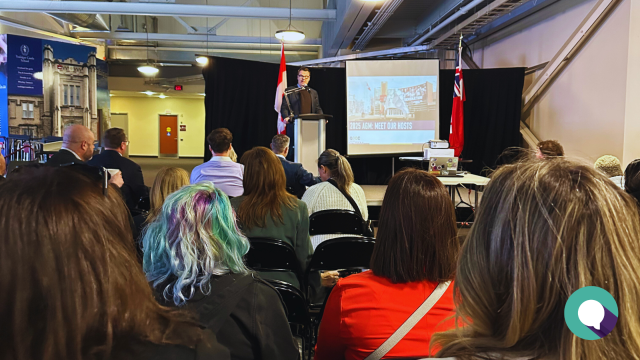 Photo of Oshawa Chamber CEO Jason King addressing the crowd at the 2025 AGM, overlain with article title Bridging Uncertainty With Unity: Insights From Our 2025 Annual General Meeting