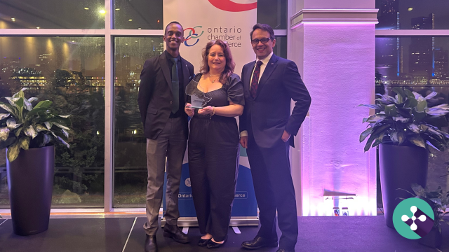 Photo of Oshawa Chamber VP Kevin Maina, Director of Member Success, Isabelle Foley, and Ontario Chamber of Commerce CEO, Daniel Tisch with the Ontario Chamber Chair’s Award for Innovative Program trophy, overlain with article title, Oshawa Chamber Wins Again: Turning Internet Debates Into Culinary Community-Building
