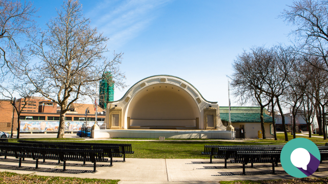 Photo of McLaughlin Bandshell, Memorial Park in downtown Oshawa. Text overlay with article title Supporting the 'Solve the Crisis' Campaign – A Call for Collective Action